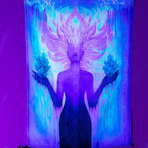May include: A tapestry featuring a woman with flowing hair and a third eye, holding two crystals in her hands. The tapestry is in shades of blue, purple, and white, with a black border.