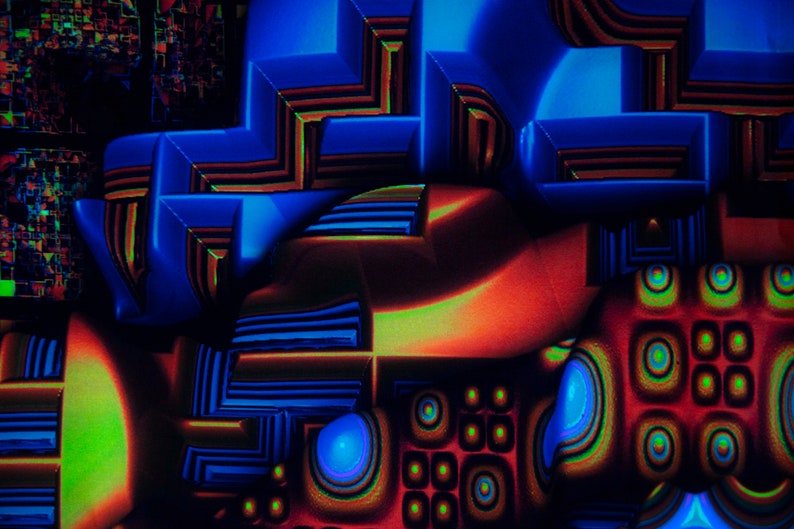 May include: Abstract digital artwork featuring a geometric pattern in shades of blue, red, and green. The design incorporates overlapping shapes and lines, creating a sense of depth and movement.