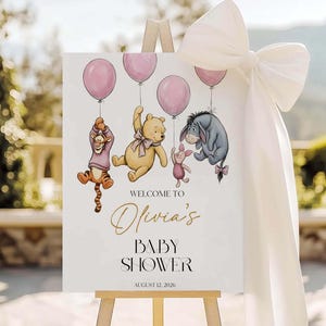 Cartello di benvenuto per baby shower a tema Winnie the Pooh, poster con orsetto e palloncino rosa, modello Canva modificabile immagine 1