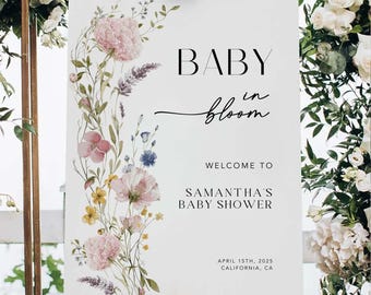 以下が含まれることがあります： 左側にピンク、黄色、青の花々をあしらった水彩画風のフラワーアレンジメントが描かれた、白い長方形のベビーシャワー用ウェルカムボード。テキストは「BABY in bloom, WELCOME TO SAMANTHA'S BABY SHOWER, APRIL 15TH, 2025, CALIFORNIA, CA」と記載されています。