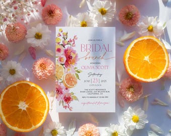May include: A rectangular bridal brunch invitation card featuring watercolor floral and orange slice illustrations. The text reads: Join us for a bridal brunch honoring Olivia Scott, Saturday, June 23, 2025, 2 o'clock, The Scott Residence.