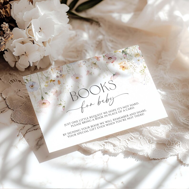 May include: A baby shower invitation card with floral design and the text "BOOKS for baby". The card has a floral border with pastel colours and a request to bring a book instead of a card.