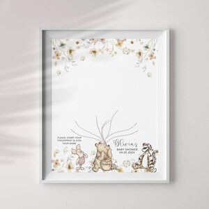May include: A Winnie the Pooh themed baby shower guest book with a floral border. The guest book features a tree with branches for guests to sign and leave their fingerprints. The text reads "Olivia's Baby Shower 04.05.2024".