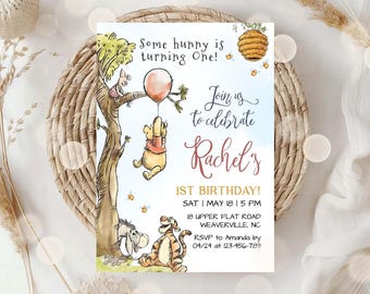 May include: A rectangular birthday invitation card featuring Winnie the Pooh characters. Text reads: Some hunny is turning One! Join us to celebrate Rachel's 1ST BIRTHDAY! SAT | MAY 18 | 5 PM 18 UPPER FLAT ROAD WEAVERVILLE, NC RSVP to Amanda by 04/24 at 123-456-789.