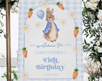 Könnte beinhalten: Ein blaues und weißes kariertes Willkommens-Schild mit einer Aquarell-Illustration eines Kaninchens, das einen blauen Ballon hält. Das Schild lautet "Willkommen zu Christopher's First Birthday 05 07 2025".