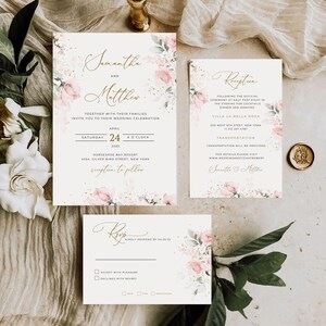 May include: Wedding invitation suite with a floral design. The invitation features a pink and white floral pattern with gold accents. The text on the invitation reads "Samantha and Matthew" and includes the date and time of the wedding. The RSVP card features a similar floral design and includes a space for guests to RSVP.