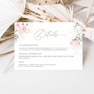 May include: A white card with pink floral accents and gold lettering. The card lists details for a wedding, including accommodations at the Rivertree Hotel in Sacramento, CA, booking information for the Horseshoe Bay Resort, and gift registry information at Macy's and Crate & Barrel.