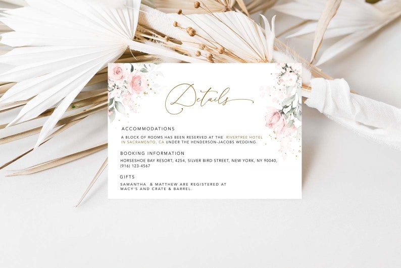 May include: A white card with pink floral accents and gold lettering. The card lists details for a wedding, including accommodations at the Rivertree Hotel in Sacramento, CA, booking information for the Horseshoe Bay Resort, and gift registry information at Macy's and Crate & Barrel.