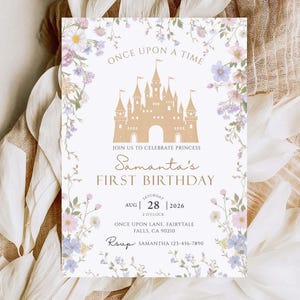 May include: A cream-coloured invitation card featuring a gold castle illustration and floral borders. The text reads "Once Upon a Time" and announces "Samantha's First Birthday" with date and time details.