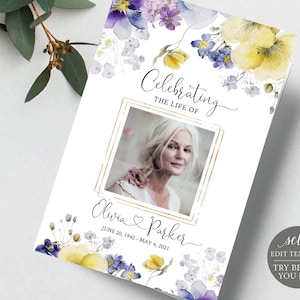 Könnte beinhalten: Eine druckbare Gedenkkartenvorlage mit einem Aquarell-Blumendesign mit lila und gelben Blumen. Die Karte hat einen goldenen Rahmen mit einem Platzhalter für ein Foto und den Text "Celebrating the Life of Olivia Parker June 20, 1942 - May 4, 2021".