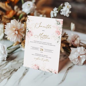 May include: Wedding invitation with a floral design featuring pink and white flowers. The invitation reads "Samantha and Matthew" with the date "April 24, 2025" and the time "6 o'clock". The invitation also includes the location "Horseshoe Bay Resort, 4254 Silver Bird Street, New York" and the phrase "Reception to follow".