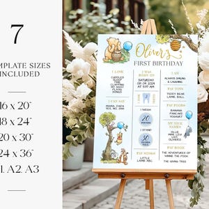 May include: A blue and white printable first birthday sign featuring Winnie the Pooh characters. The sign includes the child's name, Oliver, and details about their first year, including their birthdate, weight, and favorite foods and books.