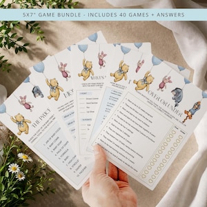 May include: A bundle of baby shower games, featuring Winnie the Pooh and friends. The games include "The Price," "What's in Your Purse," and "Over or Under." Each card has a light blue balloon design and is 5x7 inches.