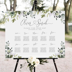 May include: A wedding seating chart with a white background and green foliage border. The chart is titled "Oliver & Sarah" with the date "September 26, 2025". The chart lists ten tables with guest names.