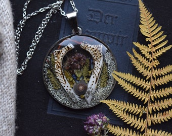 Fire bone medallion with snail shell and flowers real bones