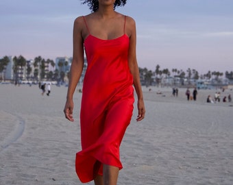Red 100% silk satin bias cut slip dress in midi length with scoop neck and spaghetti straps