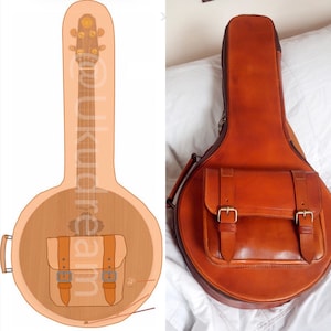 Puede incluir: Un estuche de banjo de cuero marrón con un bolsillo frontal asegurado por dos correas y hebillas. El estuche tiene un asa y un cierre de cremallera. La imagen también muestra una ilustración de banjo.