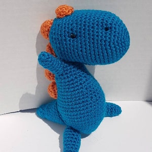 Blue dinosaur with a big head and tiny arms. Handmade. Ready to ship for newborns toddler kids and adults