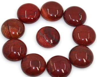 May include: Ten round, smooth, red jasper cabochons with a polished finish. The cabochons are arranged in a circle on a white background.
