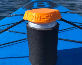 May include: Orange and black can holder with the words "CAN-SUL" printed on the top. The holder is attached to a blue and white paddleboard.
