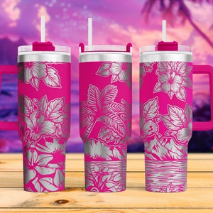 May include: Three pink stainless steel tumblers with a silver floral design. Each tumbler has a lid and a straw. The tumblers have a handle and are perfect for enjoying your favorite beverage.