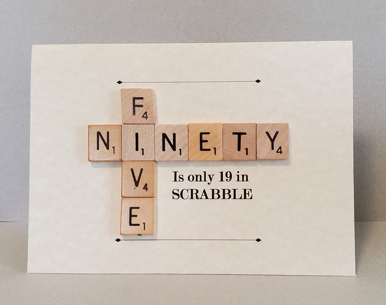 May include: A white card with the word "NINETY" spelled out using Scrabble tiles. The tiles are arranged in a cross shape. The text "Is only 19 in SCRABBLE" is printed below the tiles.