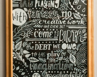 May include: A framed chalkboard with a white quote on a black background. The quote reads: "Without this playing with fantasy, no creative work has ever yet come to birth. The debt we owe to the play of imagination is incalculable." - Carl Jung.