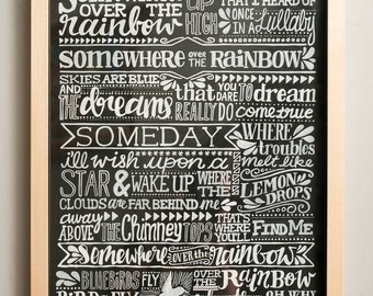 May include: A black chalkboard with white lettering that reads "Somewhere over the rainbow..." and "Someday where troubles melt like lemon drops..." The chalkboard is framed in wood.
