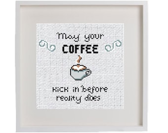 May include: White framed cross-stitch embroidery with the text "May your coffee kick in before reality does" and a pixelated image of a coffee cup with steam.