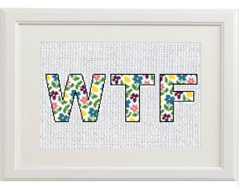 May include: A framed cross-stitch design featuring the letters "WTF" in a floral pattern with pink, yellow, blue, and purple flowers.