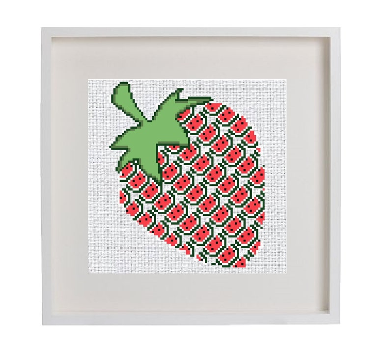 May include: A framed cross-stitch artwork depicting a red strawberry with green leaves. The strawberry is made up of smaller red strawberries with black seeds.
