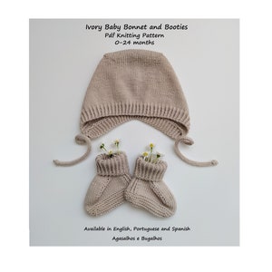 May include: Ivory knitted baby bonnet and booties knitting pattern. The pattern is available in English, Portuguese and Spanish.  Agasalhos e Bugalhos.