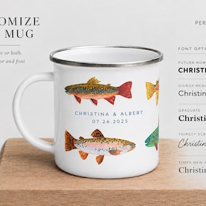 May include: A white enamel mug with a silver rim featuring colorful illustrations of trout fish and the text "CHRISTINA & ALBERT 07.26.2025". The image includes customization options for font colors, font styles, and personalization details.