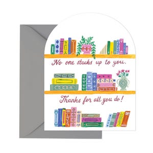 May include: A greeting card with a bookshelf illustration and the text "No one stacks up to you. Thanks for all you do!"