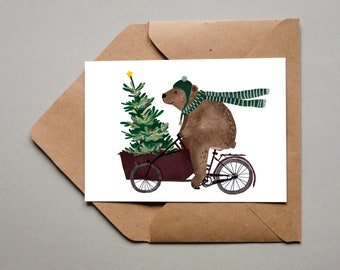 Tarjeta de Navidad - oso en bicicleta con árbol de Navidad