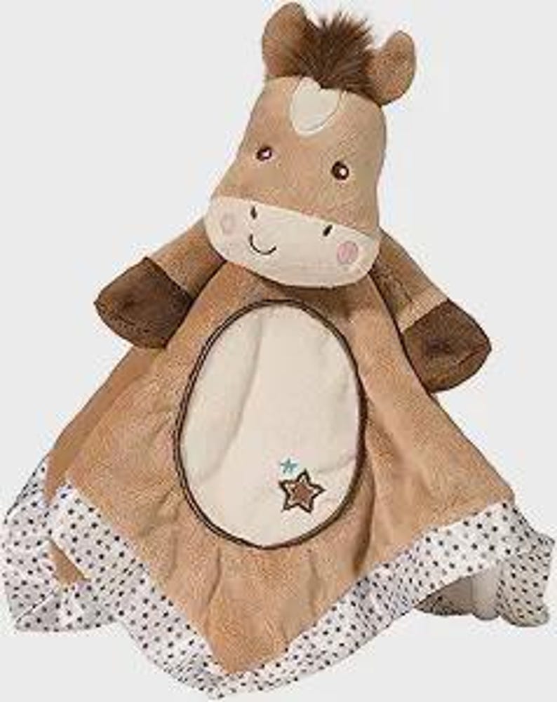 May include: A plush baby security blanket featuring a horse head and a soft, square blanket. The horse is light brown with a white face, brown mane, and embroidered details. The blanket is tan with a white and gray polka dot border and a star applique.