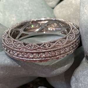 Very sparkly cushion cut CZ ring with filigree edges.