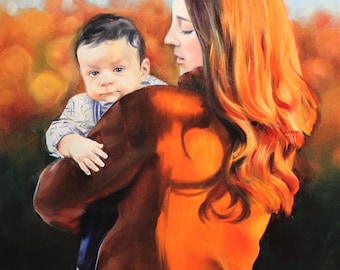 May include: A woman with long, flowing red hair holds a young child in her arms. The woman is wearing a brown jacket with an orange hue. The child is wearing a blue and white patterned shirt. The background is a blurred image of fall foliage.