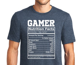 May include: A blue t-shirt featuring a white graphic of a nutrition facts label for "Gamer" with a humorous breakdown of the daily value of things like "XP (Level Ups)", "Respawns", and "Rage Quits". The label also includes the text "Order Pizza" under "Protein".