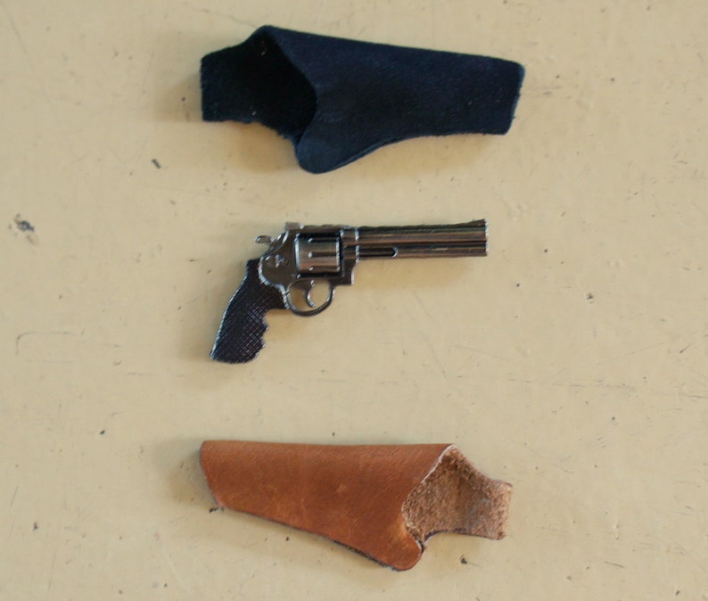 May include: A silver revolver with a black handle and two holsters, one black and one brown.