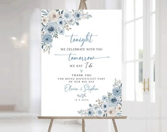 May include: A wedding sign with blue and white watercolor flowers. The sign reads "tonight we celebrate with you, tomorrow we say 'I do'. Thank you for being a significant part of our big day, Olivia & Stephen, 18.8.2023"