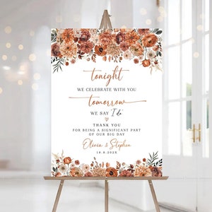 May include: A wedding welcome sign with a floral design in shades of orange and brown. The sign reads "tonight we celebrate with you, tomorrow we say 'I do'. Thank you for being a significant part of our big day. Olivia & Stephen 18.8.202X"