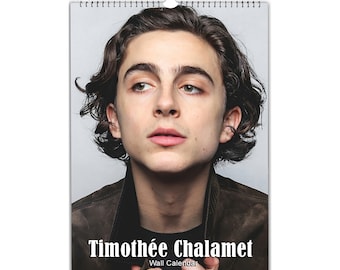 May include: A wall calendar featuring a close-up portrait of Timothée Chalamet. The image is in color and shows Chalamet looking up with a serious expression. The text "Timothée Chalamet Wall Calendar" is printed at the bottom of the image.