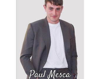 May include: A wall calendar featuring a photo of Paul Mesca. The photo shows him wearing a gray suit jacket over a white t-shirt. He is smiling and looking at the camera. The text "Paul Mesca Wall Calendar" is printed below the photo.