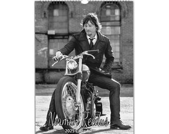 May include: Black and white photo of a man sitting on a motorcycle. The man is wearing a black coat and a tie. The motorcycle is a custom-built chopper with a large front tire. The photo is titled "Norman Reedus 2025 Calendar".