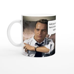 May include: White ceramic mug featuring a photograph of a man wearing a white shirt, with a speech bubble that reads "Add your name here in the speech bubble".