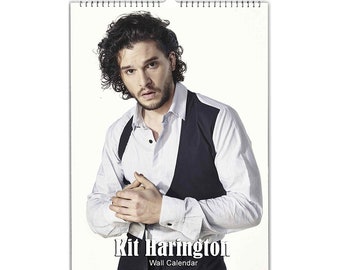 May include: A wall calendar featuring a photo of Kit Harington. The calendar has a white background and the text "Kit Harington Wall Calendar" is printed at the bottom.