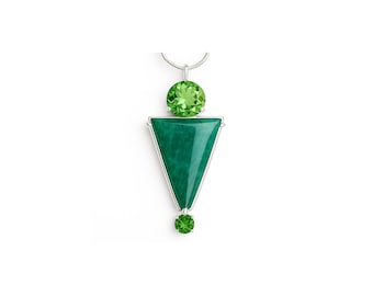 May include: A silver pendant necklace with a green gemstone triangle and two smaller green gemstones.
