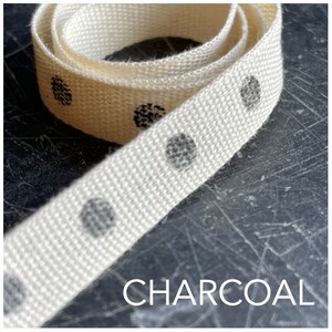 May include: White cotton ribbon with charcoal grey polka dots. The ribbon is rolled up and the text "CHARCOAL" is visible at the bottom of the image.