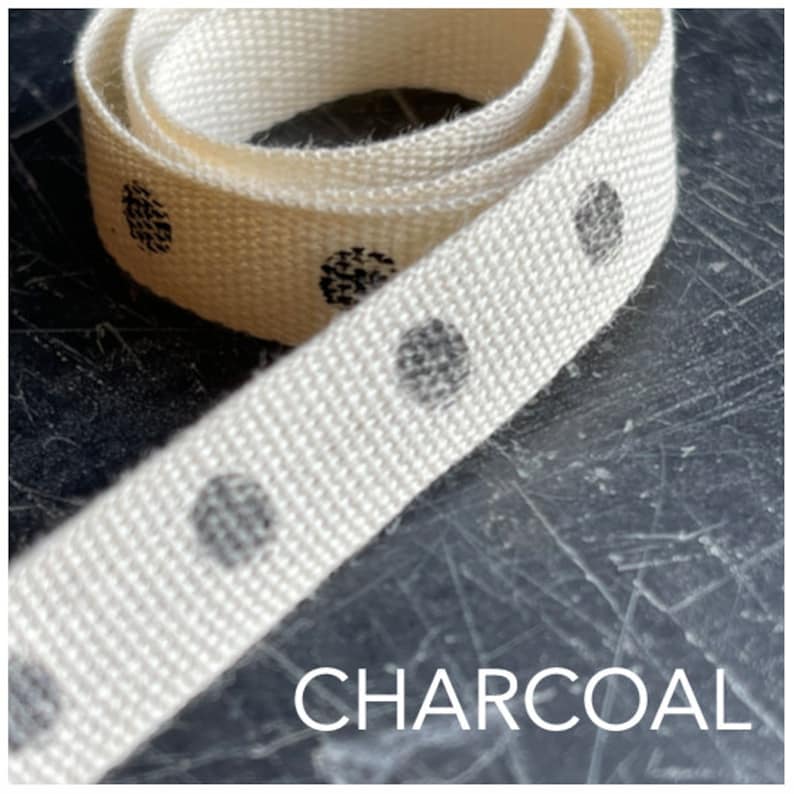 May include: White cotton ribbon with charcoal grey polka dots. The ribbon is rolled up and the text "CHARCOAL" is visible at the bottom of the image.